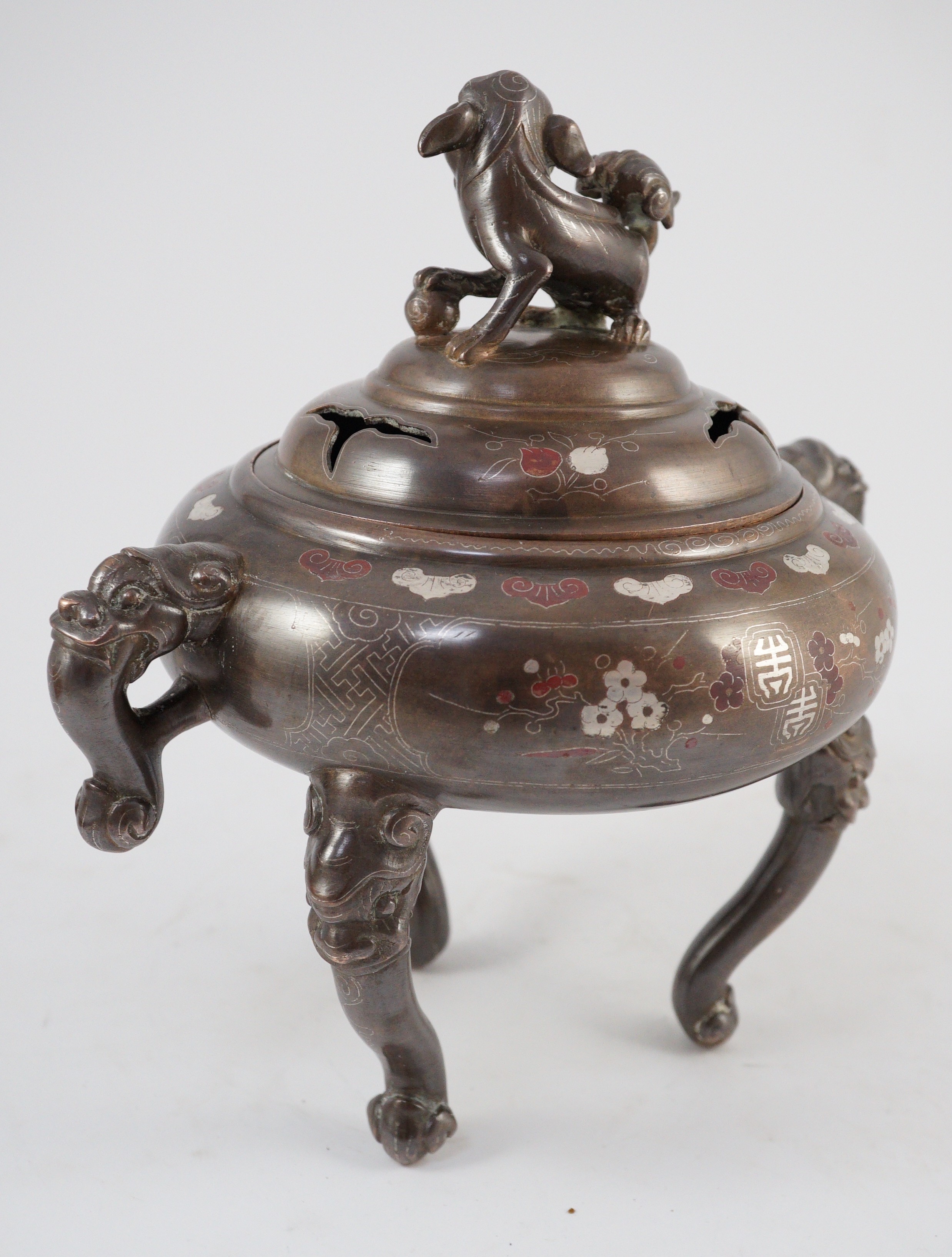 A Vietnamese silver inlaid bronze tripod censer and cover, 19th century, 24cm high, 24cm wide